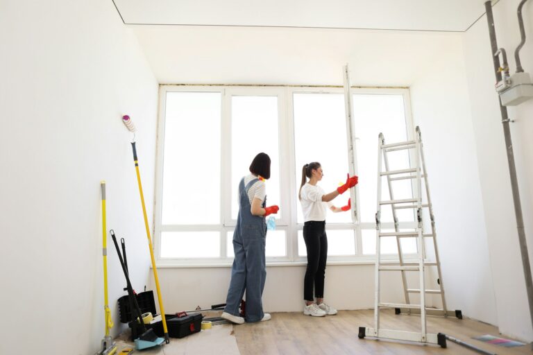 Attractive caucasian girls making house cleaning after repair.