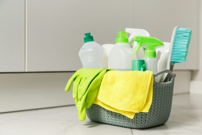 Brushes, sponges, rubber gloves and natural cleaning products in the basket. Eco-friendly cleaning