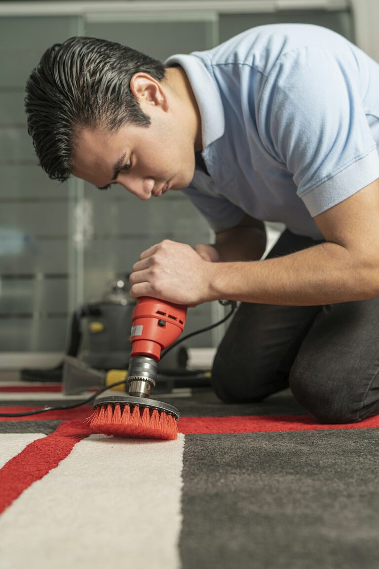 Laundry personnel cleaning carpet with special equipment